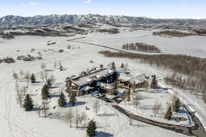 Snowy aerial view featuring a mountain view
