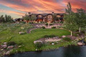 View of home's community featuring a lawn and a water view