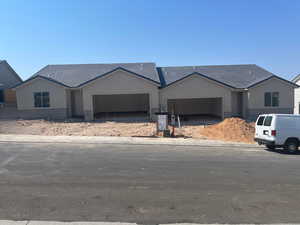 View of front of property with stucco siding and a tiled roof