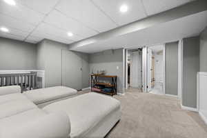 Bedroom with carpet floors, baseboards, and a drop ceiling