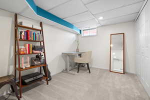 Office with carpet floors, a paneled ceiling, and baseboards