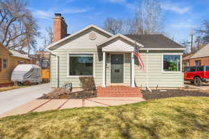 Bungalow with a chimney and a front lawn