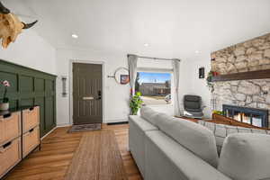 Living room featuring light wood-style floors, recessed lighting, a fireplace, and baseboards