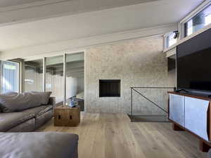 Unfurnished living room featuring wood-type flooring and a fireplace