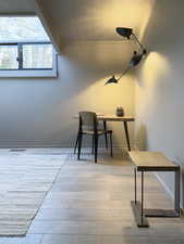 Home office with baseboards, visible vents, ornamental molding, and wood finished floors