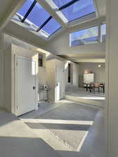 Sunroom / solarium with vaulted ceiling with skylight