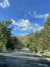 View of road featuring a mountain view and curbs