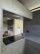 Kitchen with black electric stovetop