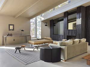 Living room with wood ceiling, a fireplace, beamed ceiling, and finished concrete flooring