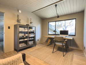 Office area with lofted ceiling with beams, wooden ceiling, wood finished floors, and baseboards