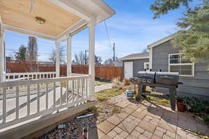 View of patio featuring fence and grilling area