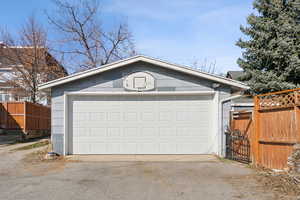 Detached garage featuring fence