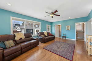 Living area with ceiling fan, baseboards, wood finished floors, and recessed lighting