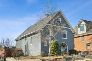 View of side of home featuring fence and stucco siding