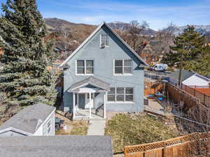 View of front of property featuring fence and a mountain view