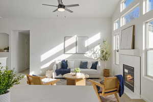 Living area with a ceiling fan and a high end fireplace