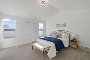 Bedroom featuring baseboards, visible vents, vaulted ceiling, and carpet flooring