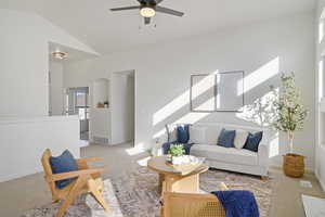 Living area with arched walkways, visible vents, a ceiling fan, vaulted ceiling, and carpet floors