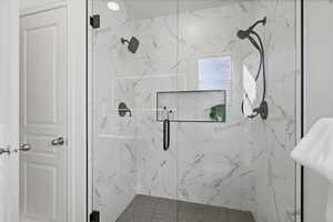 Bathroom with a marble finish shower