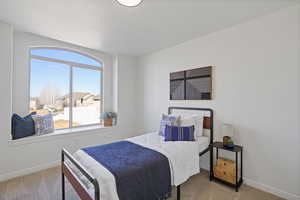 Carpeted bedroom featuring baseboards