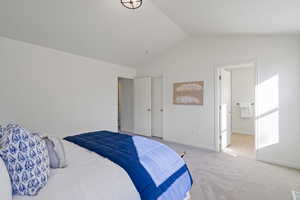 Bedroom with lofted ceiling, carpet, and baseboards