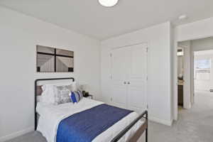 Carpeted bedroom with a closet and baseboards