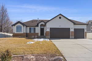 Ranch-style house with concrete driveway, brick siding, fence, and an attached garage