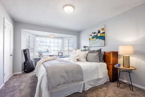 Bedroom featuring carpet floors and baseboards