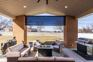 View of patio / terrace with a fenced backyard, a grill, and an outdoor living space with a fire pit