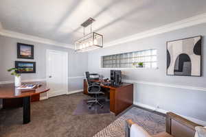 Office area with ornamental molding, carpet, a textured ceiling, and baseboards