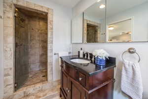 Bathroom featuring a stall shower and vanity