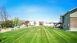 View of yard with a wooden deck and central AC