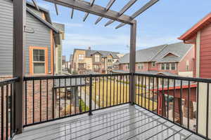 Wooden deck featuring a residential view and a pergola