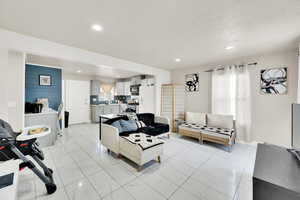 Living area featuring marble finish floor and recessed lighting