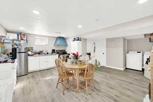 Dining space featuring light wood-type flooring, independent washer and dryer, baseboards, and recessed lighting