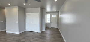Foyer with baseboards, recessed lighting, ceiling fan, and dark wood-style flooring