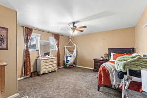 Bedroom featuring carpet flooring, ceiling fan, and baseboards