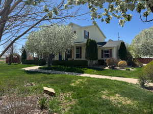 View of front facade featuring fence and a front yard