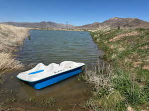 Dock area with a water and mountain view