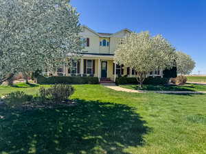View of front of home featuring a front lawn and covered porch