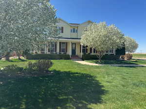 View of front facade with a porch and a front lawn