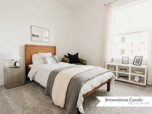 Bedroom featuring light colored carpet