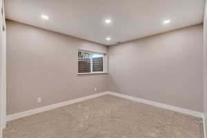 Carpeted empty room with recessed lighting, visible vents, and baseboards