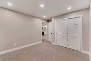 Unfurnished bedroom with baseboards, a closet, carpet flooring, and recessed lighting