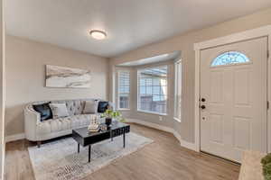 Entryway with baseboards and light wood finished floors