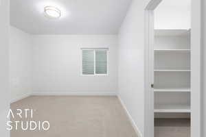 Interior space with carpet, baseboards, and a textured ceiling