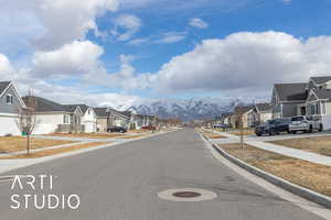 View of street with sidewalks, a residential view, and a mountain view