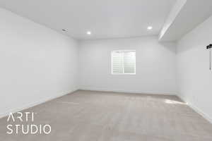 Unfurnished room with carpet, visible vents, baseboards, and recessed lighting