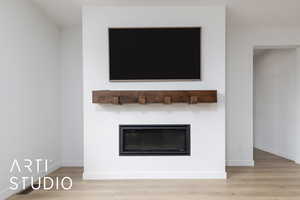 Room details with a glass covered fireplace, baseboards, and wood finished floors