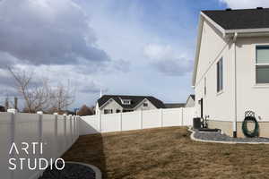 View of yard featuring central air condition unit and a fenced backyard